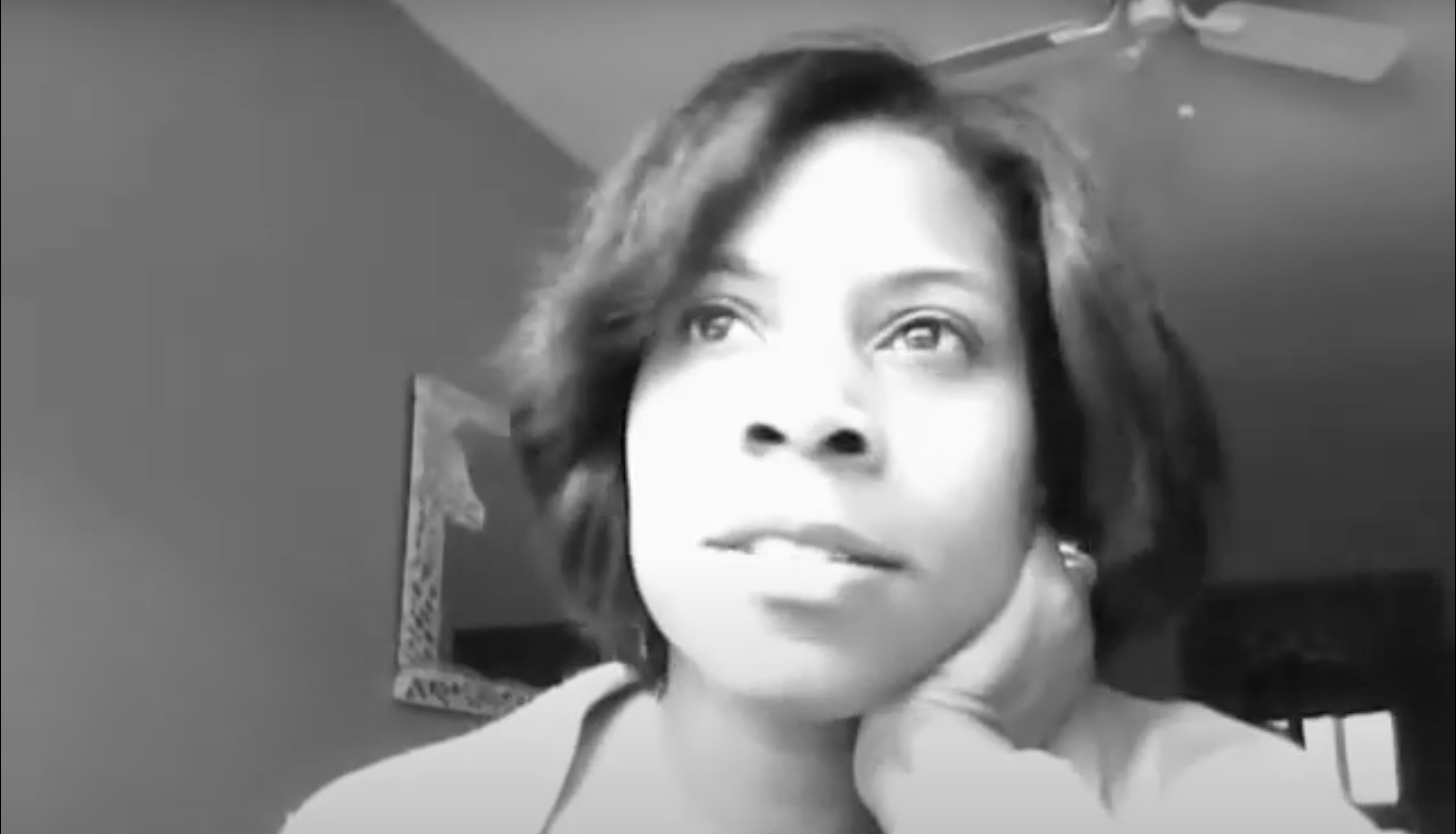 Screenshot of one of author Cerece Murphy's first ever YouTube videos. It's in black and white, a close up of Cerece leaning her chin on her hand and looking up into the distance.